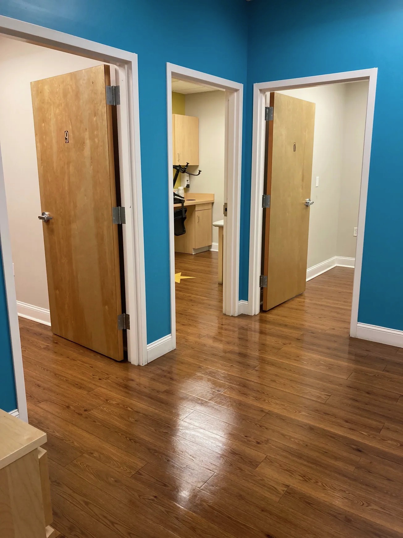 Freshly cleaned medical office hallway with polished wood floors